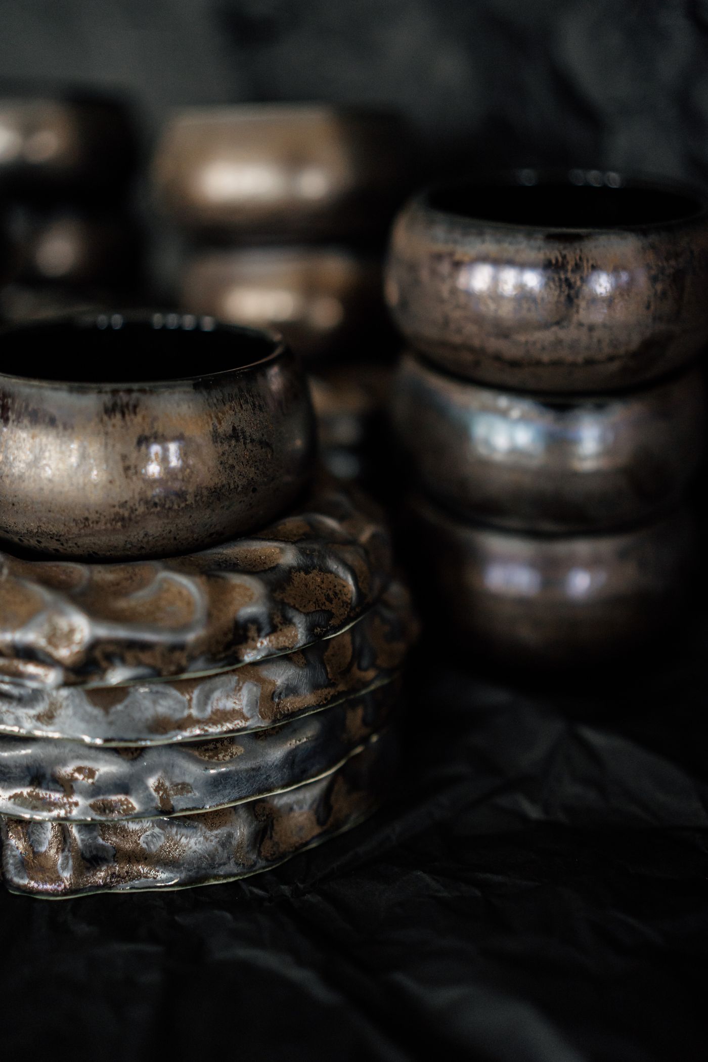 Handmade pottery bowls with a dark metallic glaze