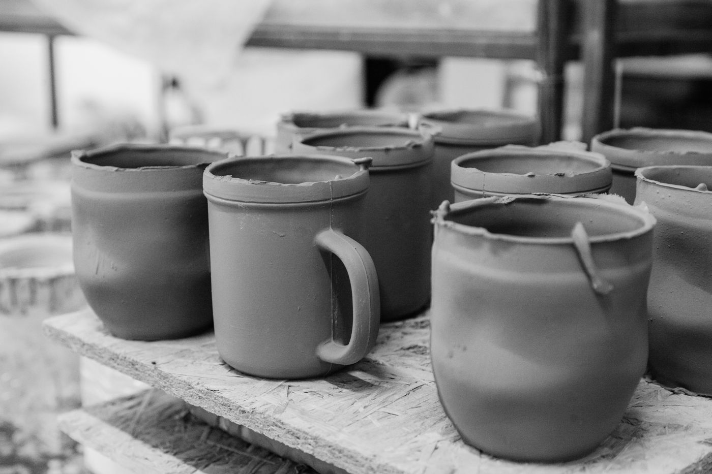 Hand-built clay cups drying before firing